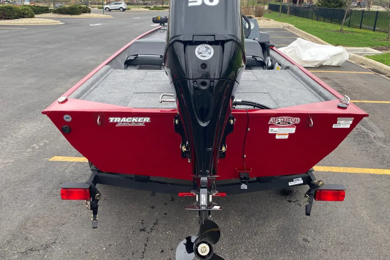 Slide: The Image of 2026 Tracker Bass Tracker Classic XL boat, red exterior, parked in a lot. - 64