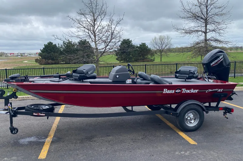 Slide: The Image of 2026 Tracker Bass Tracker Classic XL boat on trailer, parked outdoors. - 65