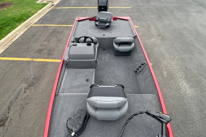 Slide: The Image of 2026 Tracker Bass Tracker Classic XL boat interior with gray seating and steering console. - 69
