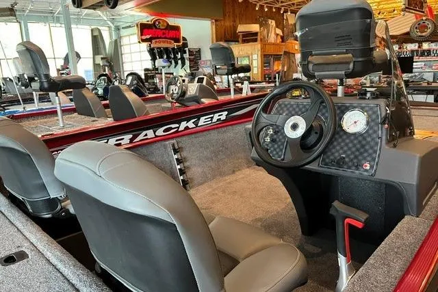 Slide: The Image of 2026 Tracker Bass Tracker Classic XL boat interior with steering wheel and seating. - 5