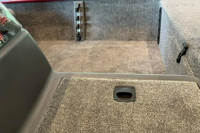 Slide: The Image of Interior of 2026 Tracker Bass Tracker Classic XL boat, featuring carpeted flooring and storage compartment. - 6