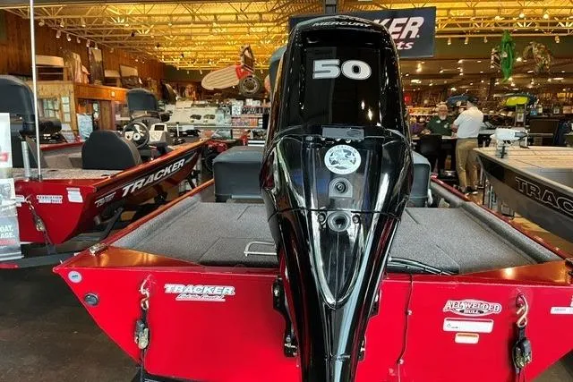 Slide: The Image of 2026 Tracker Bass Tracker Classic XL boat with a 50 HP Mercury engine displayed indoors. - 7