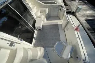 Slide: The Image of 2004 Carver 420 Mariner yacht deck with seating and dock view. - 12