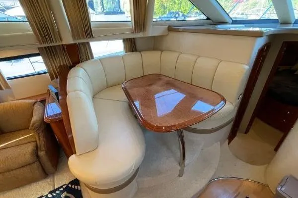 Slide: The Image of Luxurious interior of 2004 Carver 420 Mariner yacht with plush seating and wooden table. - 14