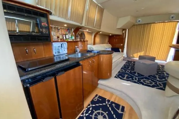 Slide: The Image of Luxurious interior of 2004 Carver 420 Mariner yacht with modern kitchen and seating area. - 16
