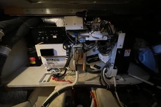 Slide: The Image of Engine room of a 2004 Carver 420 Mariner, showcasing mechanical components and wiring. - 17