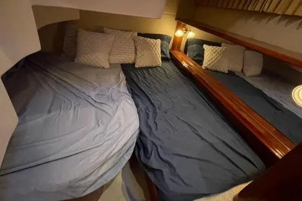 Slide: The Image of Cozy bedroom in 2004 Carver 420 Mariner yacht with blue bedding and pillows. - 19