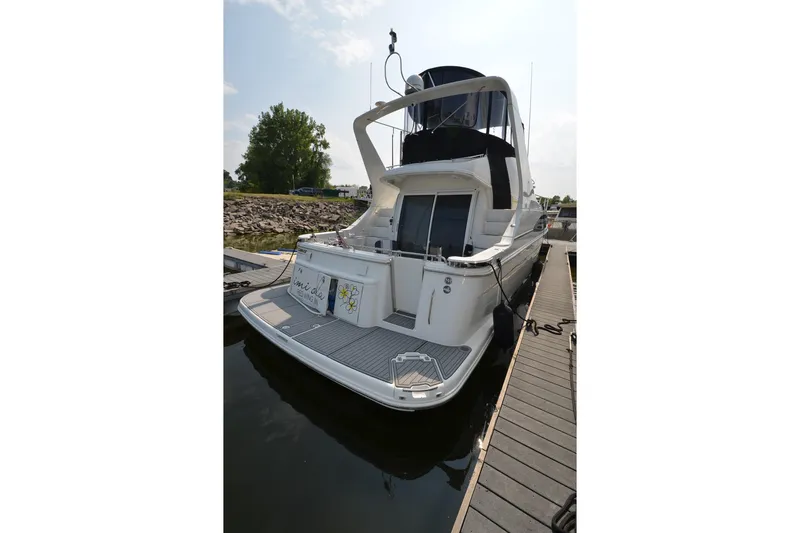 Slide: The Image of 2004 Carver 420 Mariner yacht docked at marina, rear view. - 2