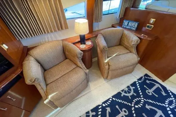 Slide: The Image of Interior of 2004 Carver 420 Mariner with cozy seating and nautical-themed decor. - 21