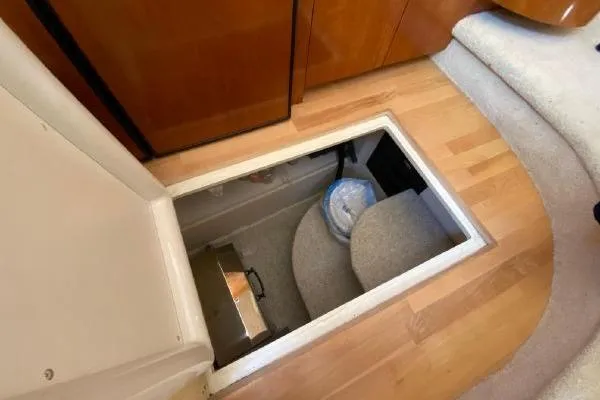 Slide: The Image of Storage compartment in 2004 Carver 420 Mariner yacht, featuring wooden flooring and carpeted interior. - 28