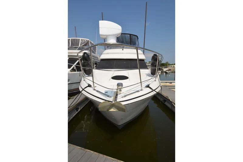 Slide: The Image of Front view of a 2004 Carver 420 Mariner yacht docked in a marina. - 3