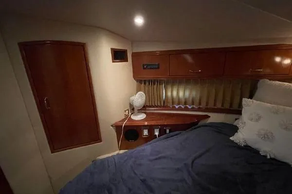 Slide: The Image of Cozy cabin interior of 2004 Carver 420 Mariner with bed and wooden cabinetry. - 30