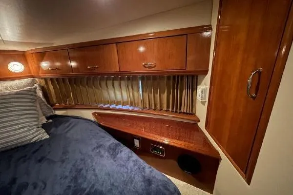 Slide: The Image of Luxurious cabin interior of 2004 Carver 420 Mariner with wood cabinetry and cozy bedding. - 31