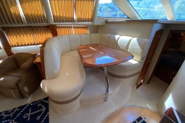 Slide: The Image of Luxurious interior of 2004 Carver 420 Mariner yacht with plush seating and elegant table. - 33
