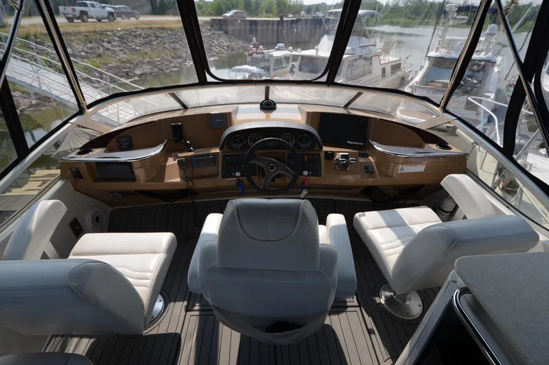 Slide: The Image of Interior view of 2004 Carver 420 Mariner yacht cockpit with steering wheel and seating. - 5