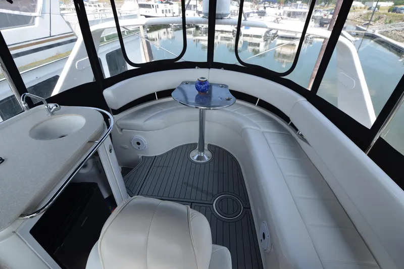 Slide: The Image of Luxurious interior of 2004 Carver 420 Mariner yacht with white seating and table. - 6