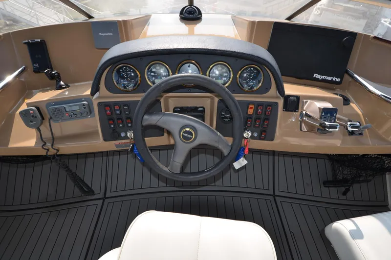 Slide: The Image of Dashboard of a 2004 Carver 420 Mariner yacht with steering wheel and navigation instruments. - 9