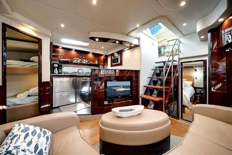 Slide: The Image of Luxurious interior of 2012 Sea Ray 610 Sundancer yacht with modern kitchen and cozy seating area. - 25