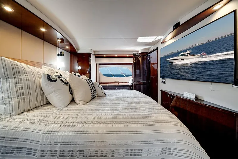 Slide: The Image of Luxurious interior of 2012 Sea Ray 610 Sundancer yacht with elegant bedroom and large window view. - 34