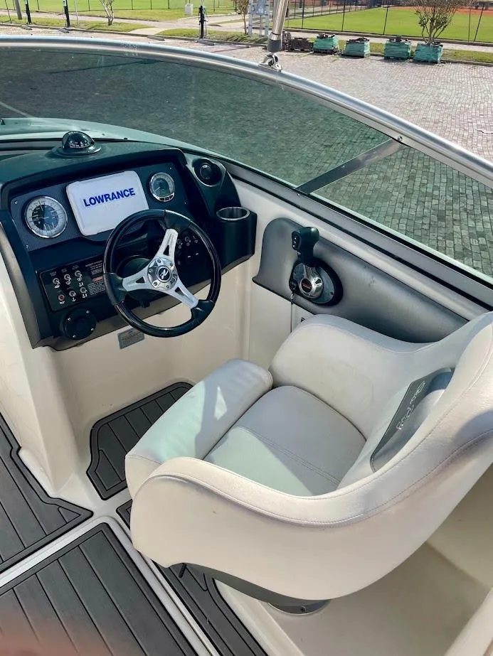 Slide: The Image of 2010 Sea Ray 300 Sundeck cockpit with steering wheel and Lowrance display. - 10