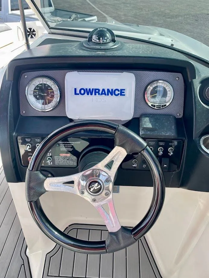 Slide: The Image of Steering wheel and dashboard of 2010 Sea Ray 300 Sundeck with Lowrance display. - 11