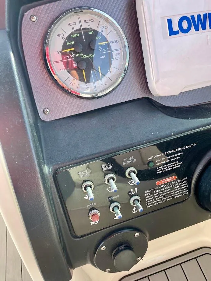 Slide: The Image of Control panel of 2010 Sea Ray 300 Sundeck boat with gauges and switches. - 12