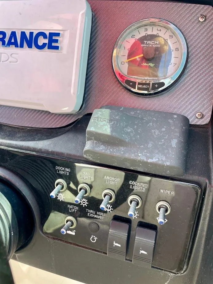 Slide: The Image of Control panel of 2010 Sea Ray 300 Sundeck boat with switches and tachometer. - 13