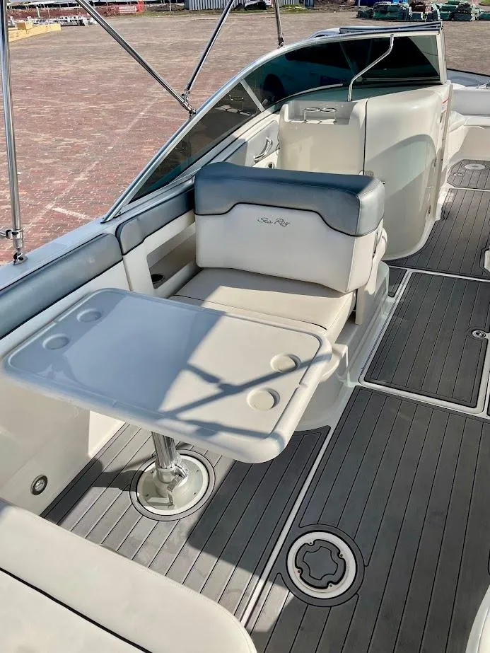 Slide: The Image of 2010 Sea Ray 300 Sundeck interior with seating and table on deck. - 16