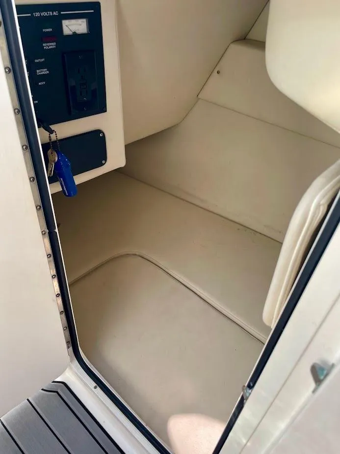 Slide: The Image of 2010 Sea Ray 300 Sundeck interior cabin with control panel and key. - 21