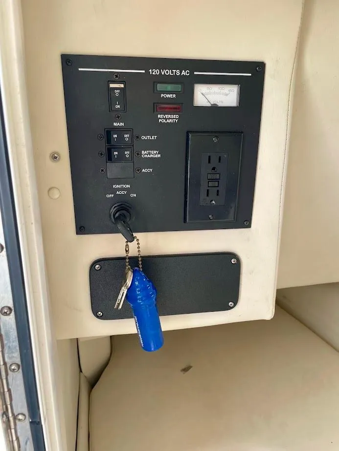 Slide: The Image of Control panel of a 2010 Sea Ray 300 Sundeck boat with key and outlet. - 23
