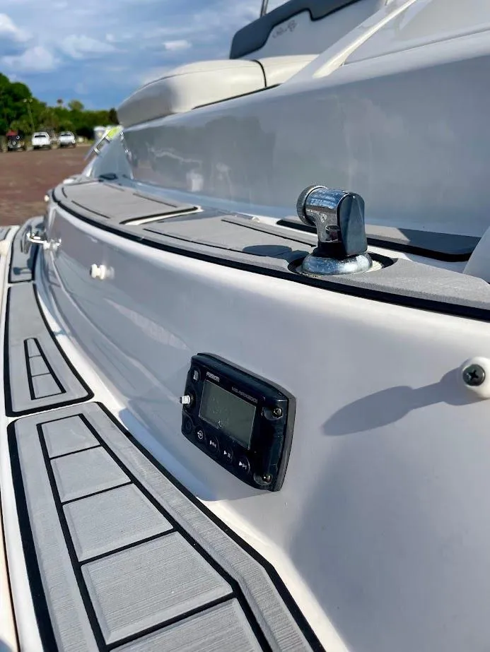 Slide: The Image of 2010 Sea Ray 300 Sundeck boat with sleek deck design and control panel. - 24