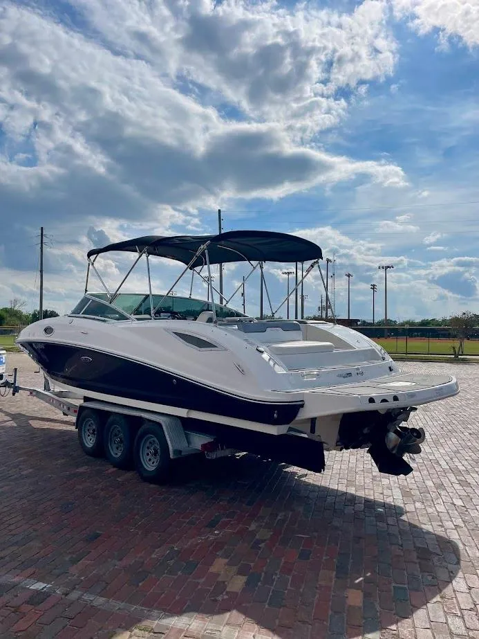 Slide: The Image of 2010 Sea Ray 300 Sundeck boat on trailer under a partly cloudy sky. - 5