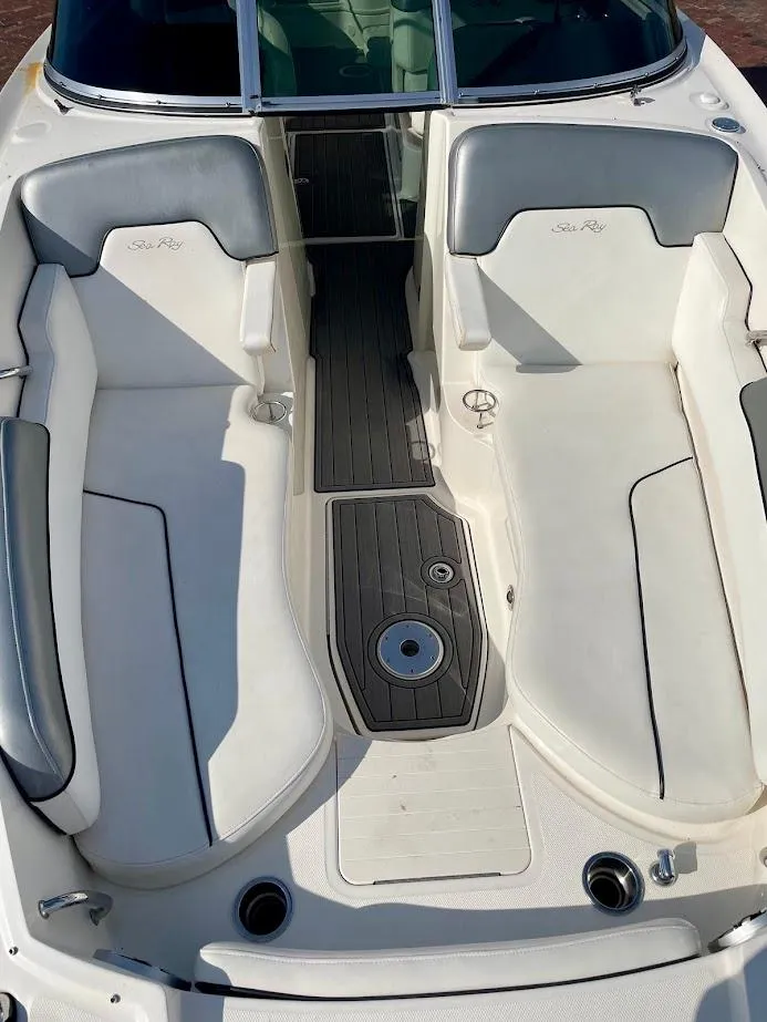 Slide: The Image of 2010 Sea Ray 300 Sundeck interior with white seating and gray accents. - 7