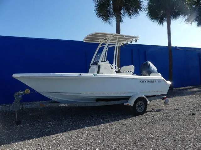 The Image of Key West 189 FS boat 2026 on trailer, blue background. - 1