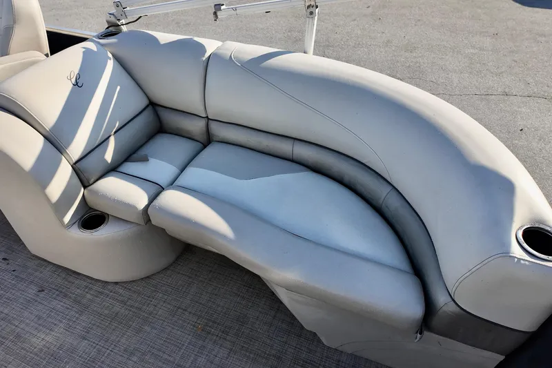Slide: The Image of Luxurious seating on 2022 Cypress Cay Seabreeze 232 pontoon boat, featuring plush upholstery and cup holders. - 3