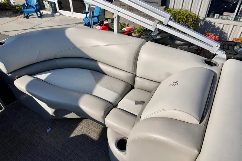 Slide: The Image of 2022 Cypress Cay Seabreeze 232 boat interior with plush seating and cup holders. - 4