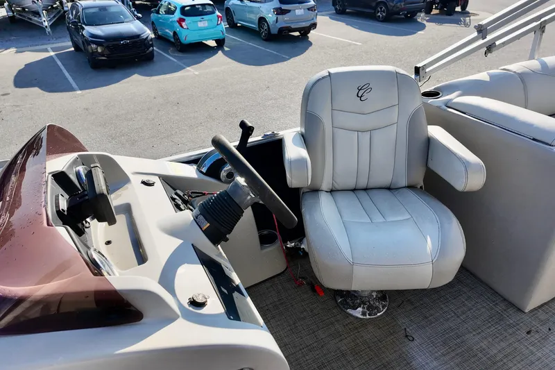 Slide: The Image of Captain's chair and helm of 2022 Cypress Cay Seabreeze 232 pontoon boat in parking lot. - 6