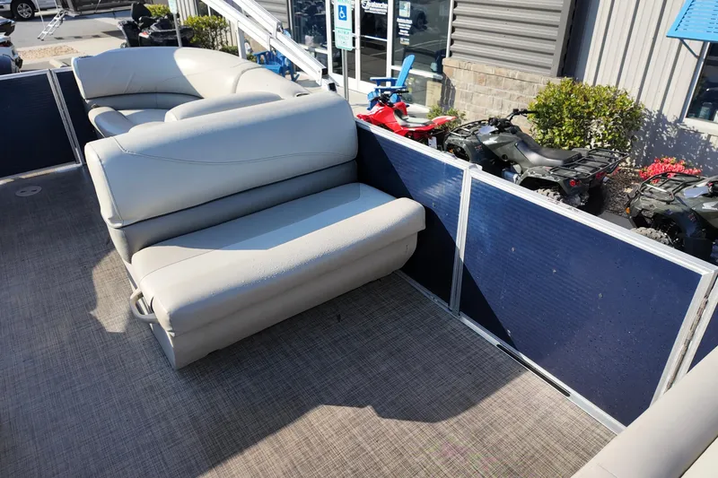 Slide: The Image of 2022 Cypress Cay Seabreeze 232 pontoon boat interior with beige seating and blue paneling. - 7