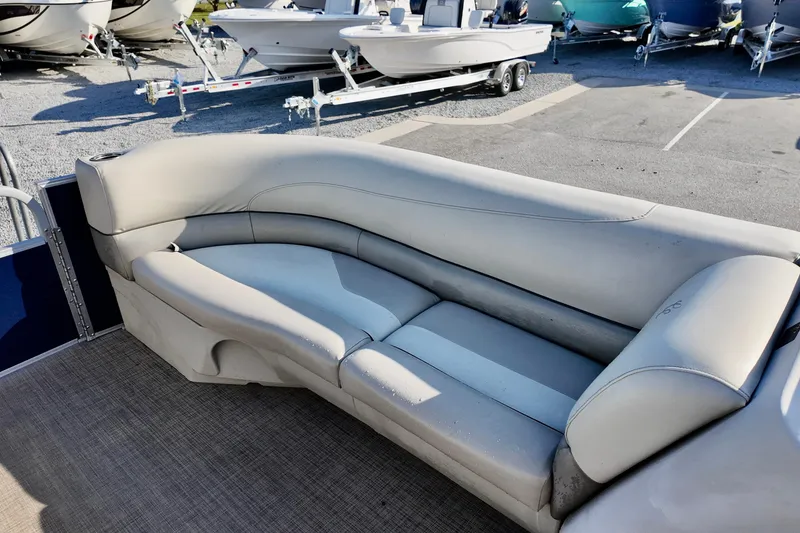 Slide: The Image of Luxurious seating on 2022 Cypress Cay Seabreeze 232 pontoon boat, with boats in background. - 9