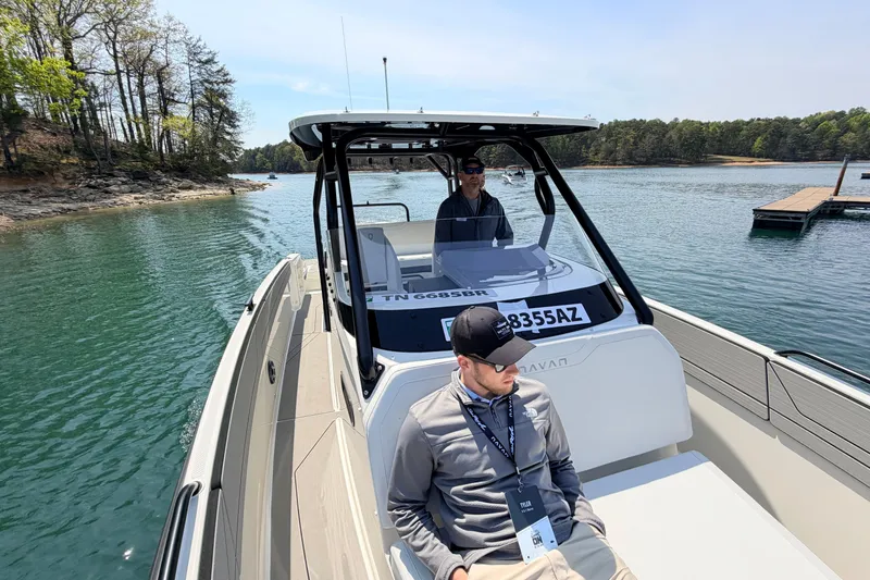 Slide: The Image of 2027 Navan T30 boat cruising on a scenic lake with two passengers onboard. - 10