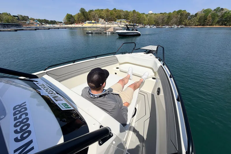 Slide: The Image of Man relaxing on a 2027 Navan T30 boat, enjoying a sunny day on the water. - 11
