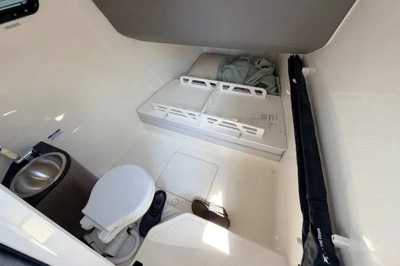 Slide: The Image of Interior of 2027 Navan T30 boat cabin with toilet and compact sleeping area. - 14