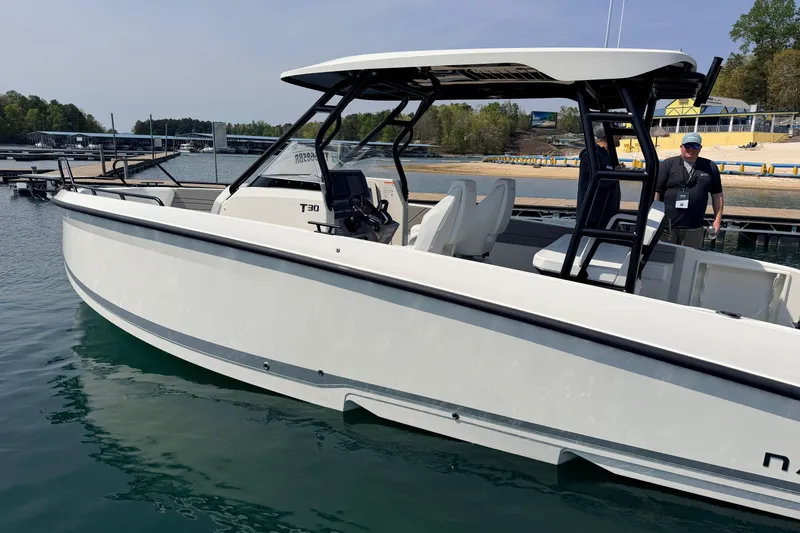 Slide: The Image of Navan T30 2027 boat docked on a sunny day, showcasing sleek design and modern features. - 2