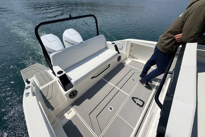 Slide: The Image of Navan T30 boat deck with dual Mercury engines, 2027 model, person leaning on railing. - 4