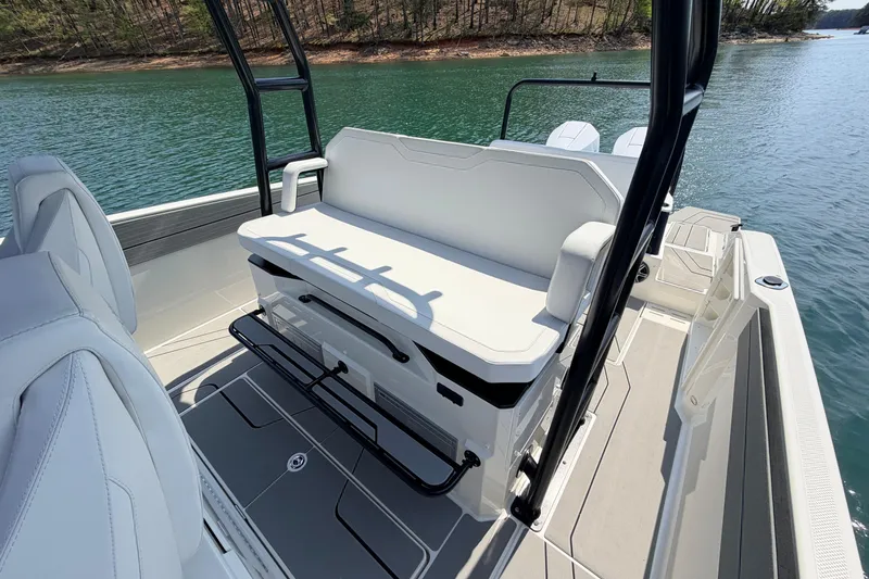 Slide: The Image of 2027 Navan T30 boat interior with white seating, sleek design, and scenic water view. - 6