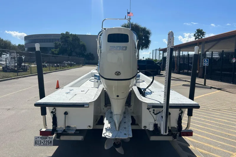 Slide: The Image of 2021 Shallow Stalker CAT-204 Pro boat with 200 HP engine in a parking lot. - 13