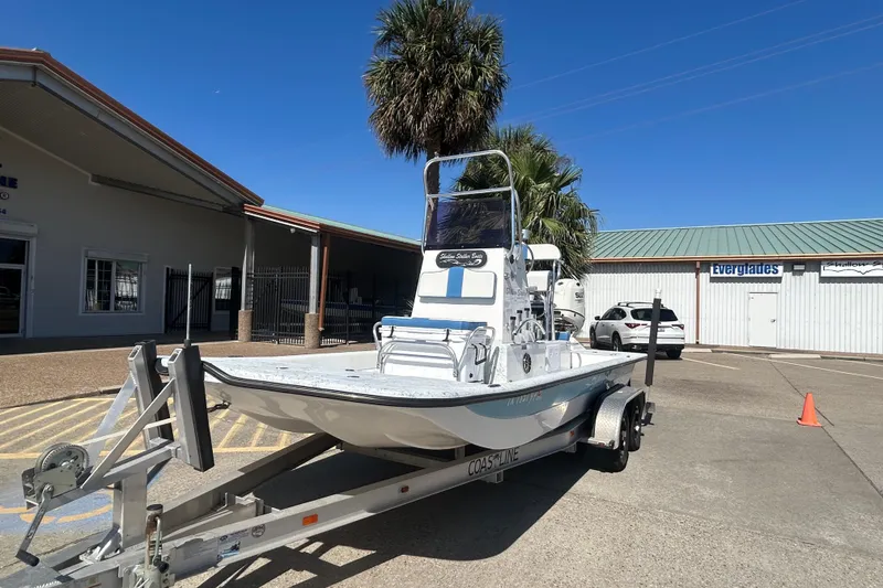 Slide: The Image of 2021 Shallow Stalker CAT-204 Pro boat on trailer in sunny parking lot. - 2