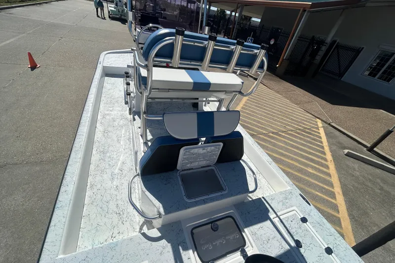 Slide: The Image of 2021 Shallow Stalker CAT-204 Pro boat with blue and white seating, docked outdoors. - 3