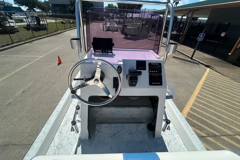 Slide: The Image of 2021 Shallow Stalker CAT-204 Pro boat console with steering wheel and controls. - 4