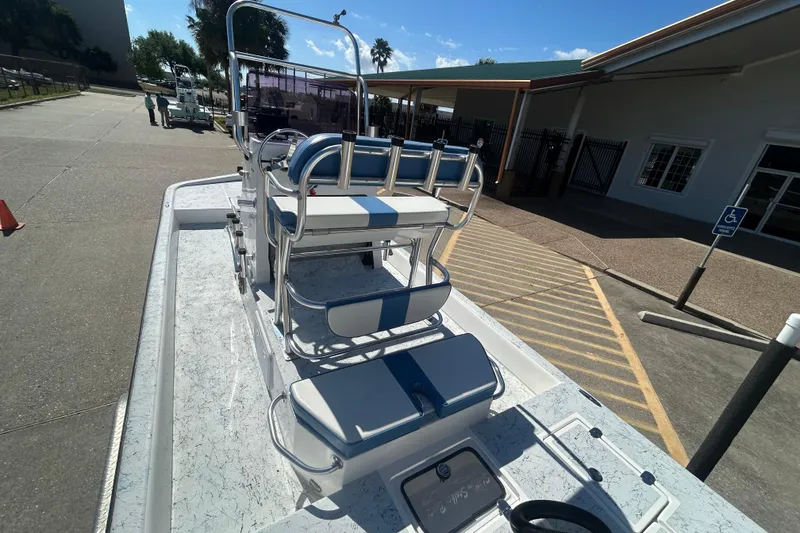 Slide: The Image of 2021 Shallow Stalker CAT-204 Pro boat parked near a building under clear skies. - 8